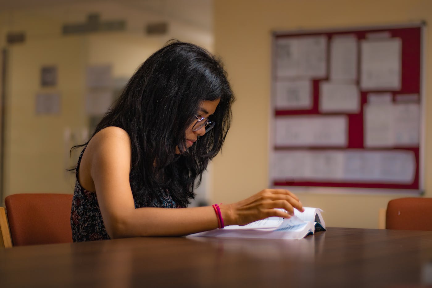 Indian student reading in a library while preparing a GKS application timeline