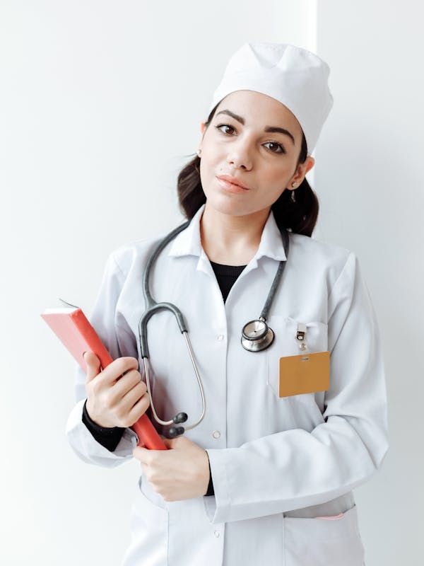 Healthcare professional holding credential documents for overseas verification