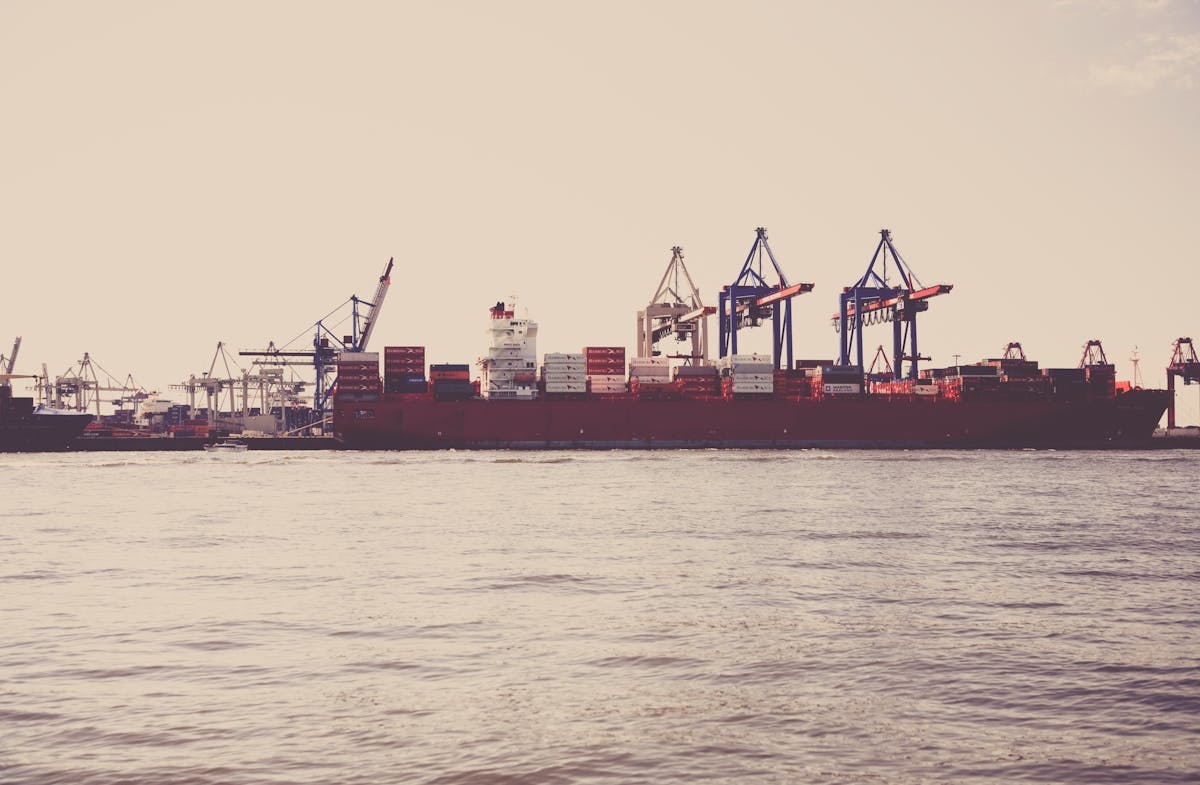 Cargo ship loaded with containers at a Saudi seaport under clear skies