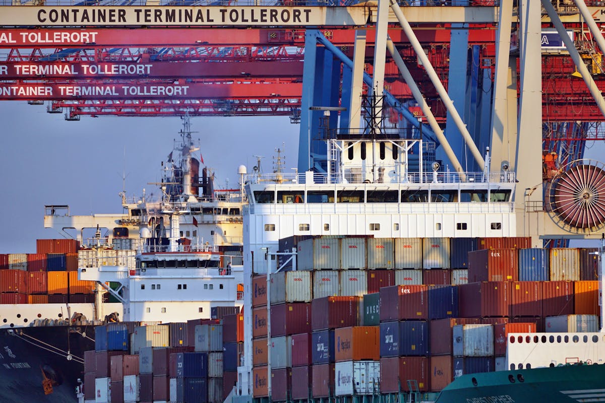 Container ships docked at an African seaport terminal at sunset