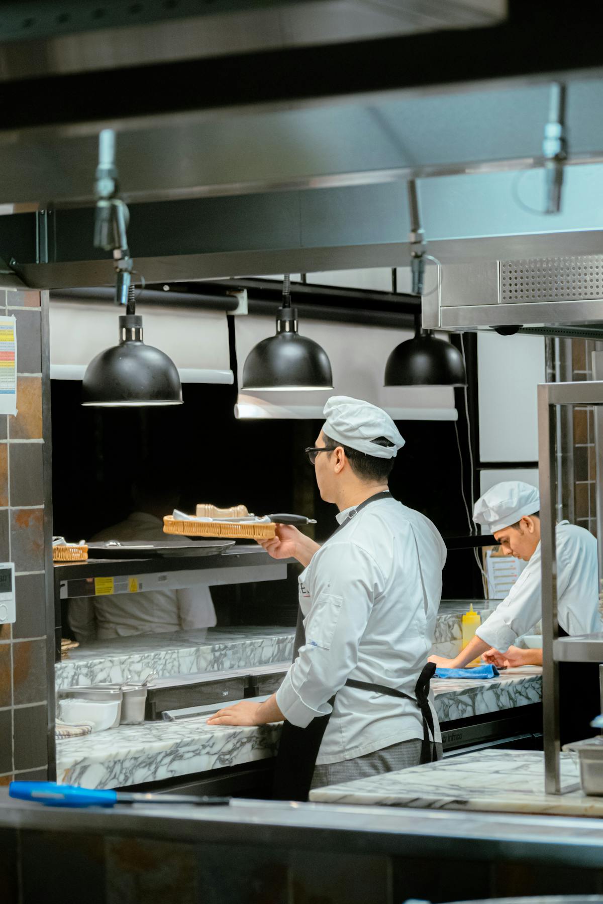 Indian chef preparing food in a Dubai hotel kitchen, the kind of hospitality role that needs UAE embassy attestation and