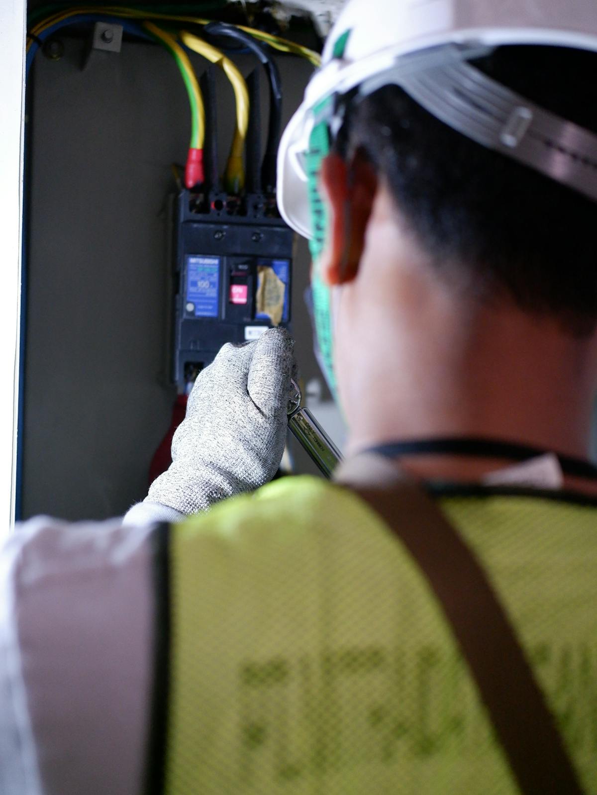 Indian electrician working on a switchboard at a UAE facility