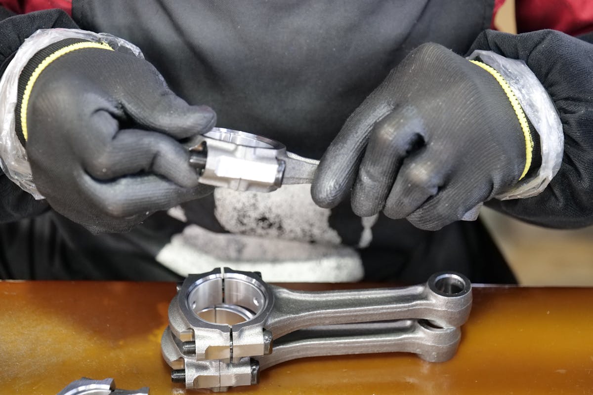 Indian engineer working on an engine assembly at a German automotive plant