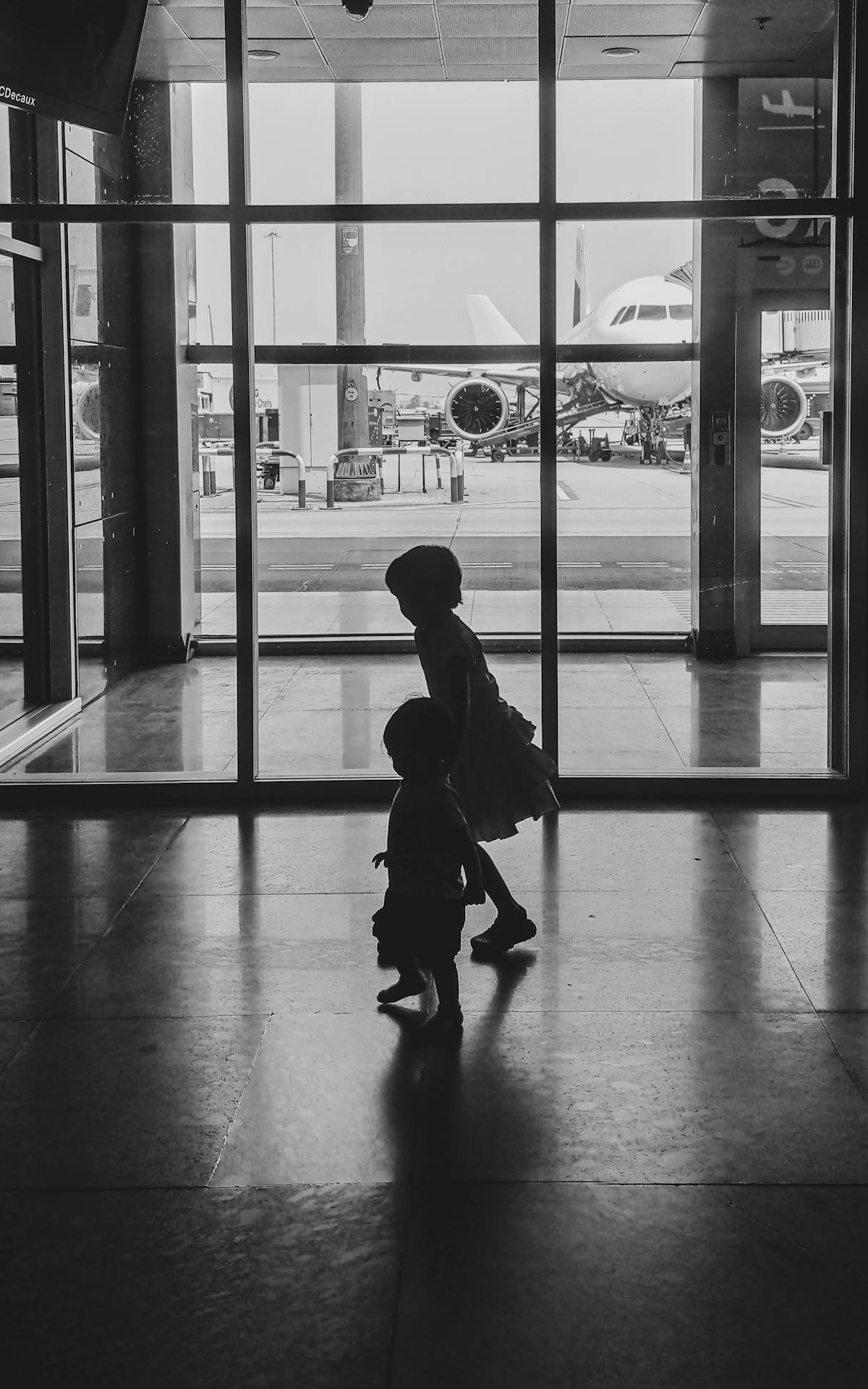 Indian family walking with luggage through a Doha airport terminal toward their flight