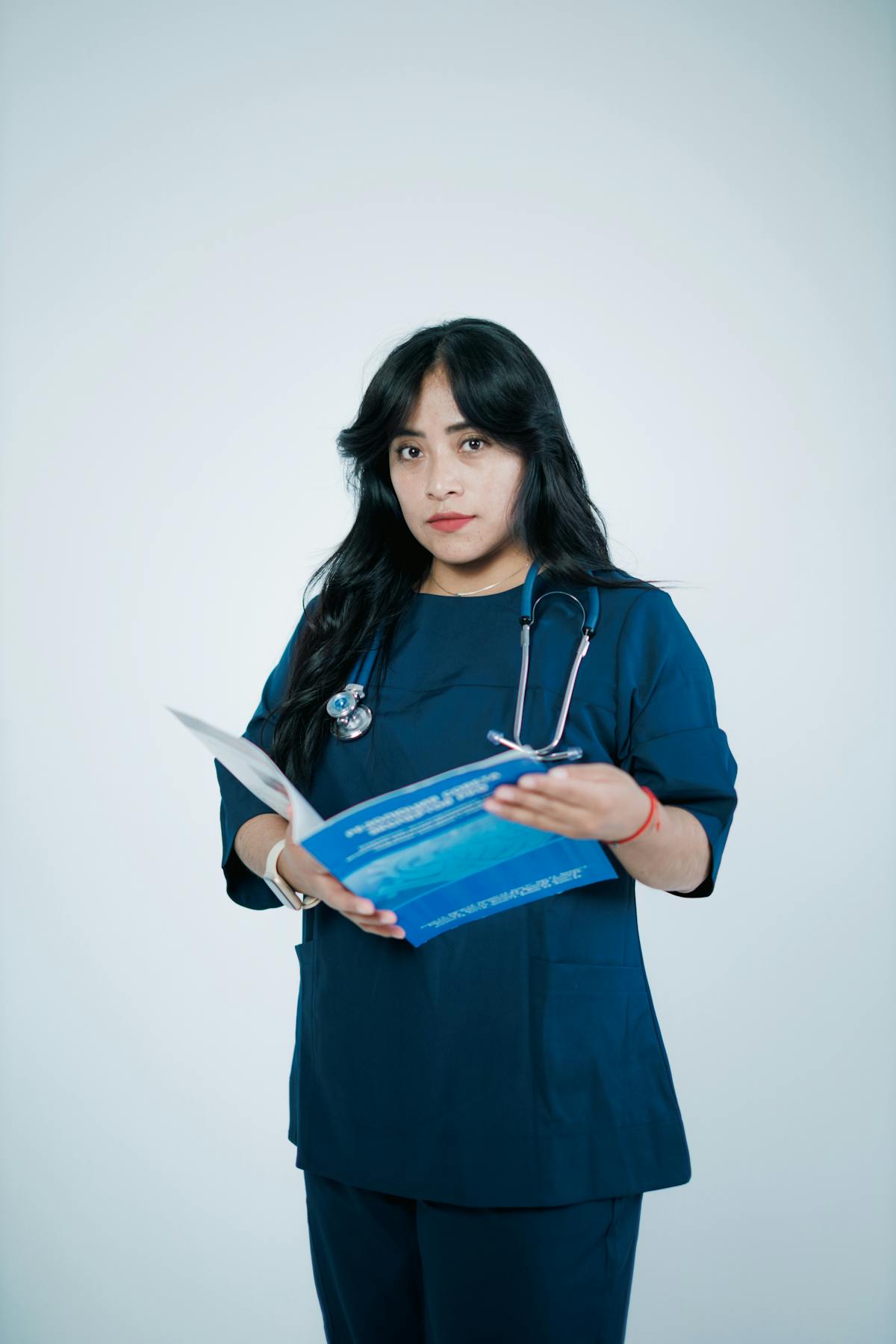 Indian pharmacist selecting medication from a pharmacy shelf in the US