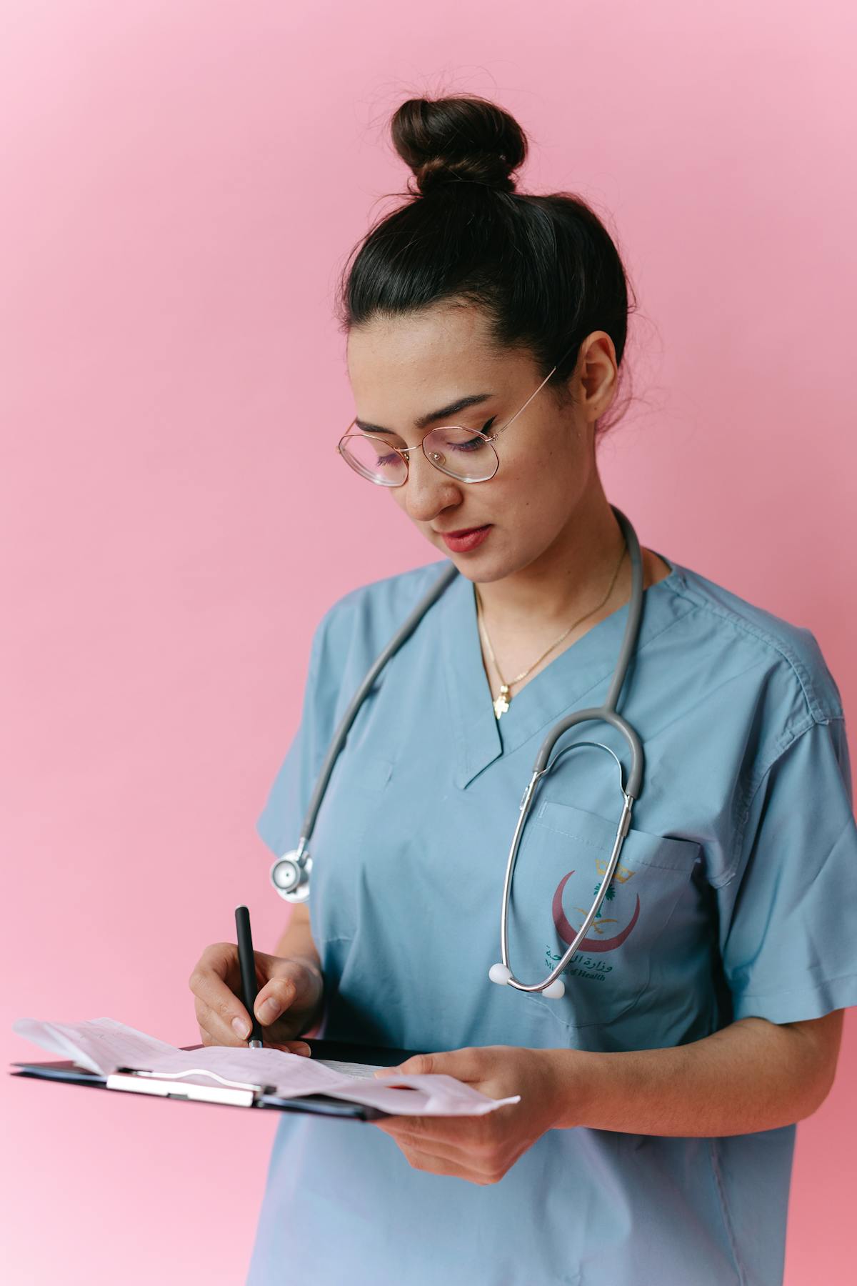 Indian nurse reviewing patient notes on a Saudi hospital ward after MEA apostille in India and DataFlow primary source