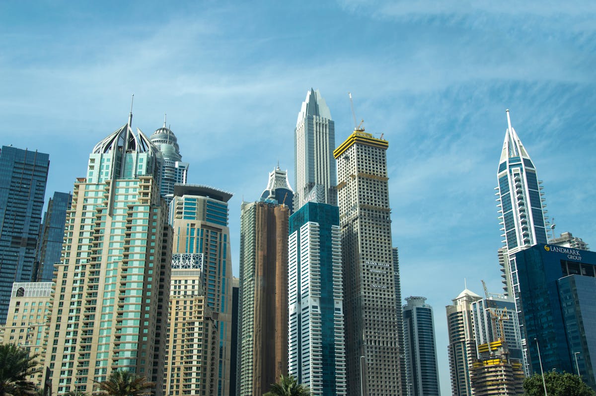 Indian professional looking over a Gulf city skyline at dusk, planning GCC document attestation and apostille from India