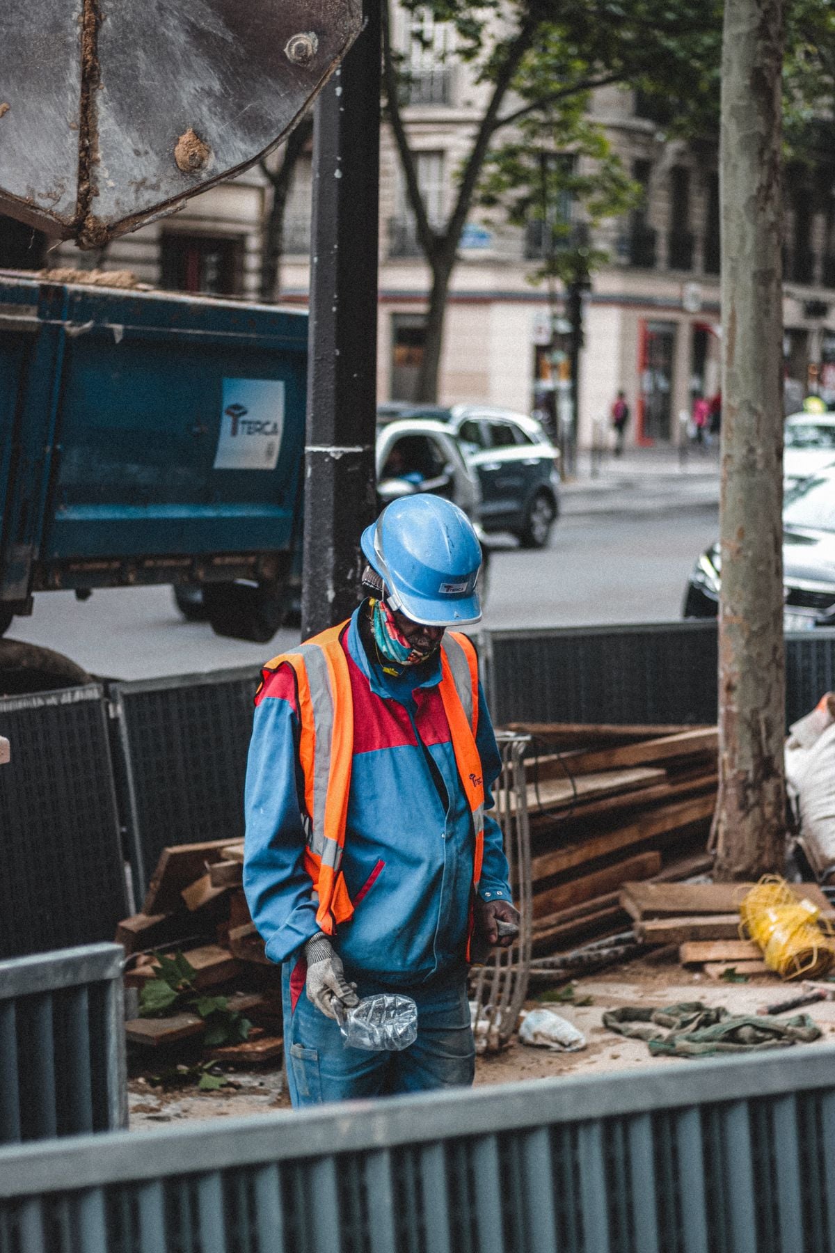 Indian project manager in a protective helmet at a Qatar infrastructure site, whose engineering degree needs Qatar