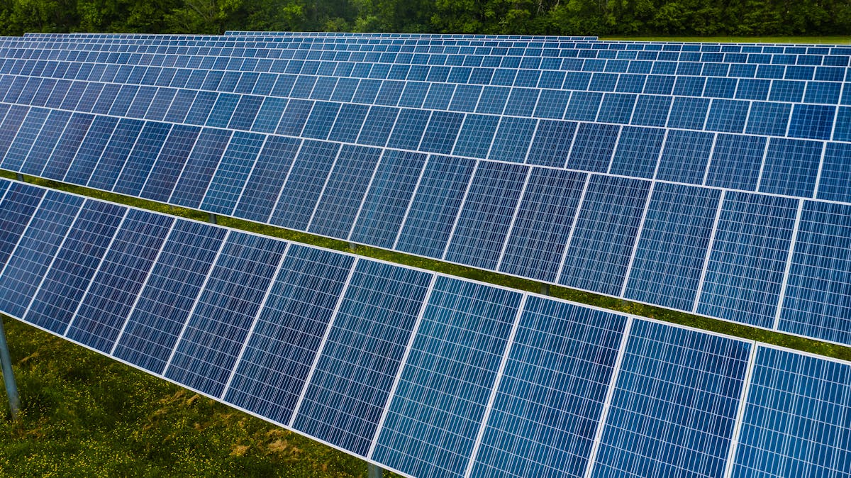 Indian sustainability engineer inspecting solar panels at the Mohammed bin Rashid Al Maktoum Solar Park in Dubai, whose
