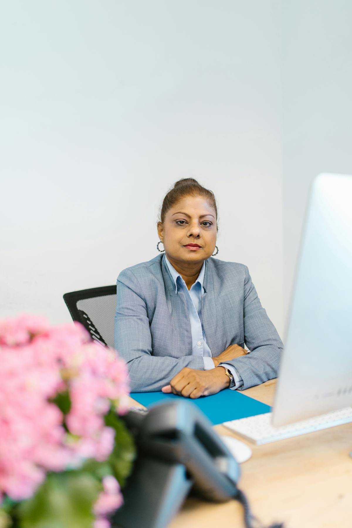 Indian woman professional at a desk in a modern Dubai office