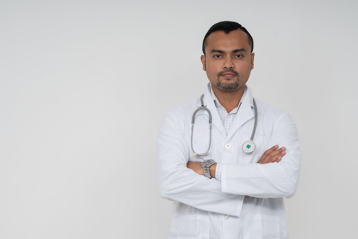 Indian doctor in a white coat with stethoscope at a UAE clinic, ready for UAE embassy attestation, degree attestation