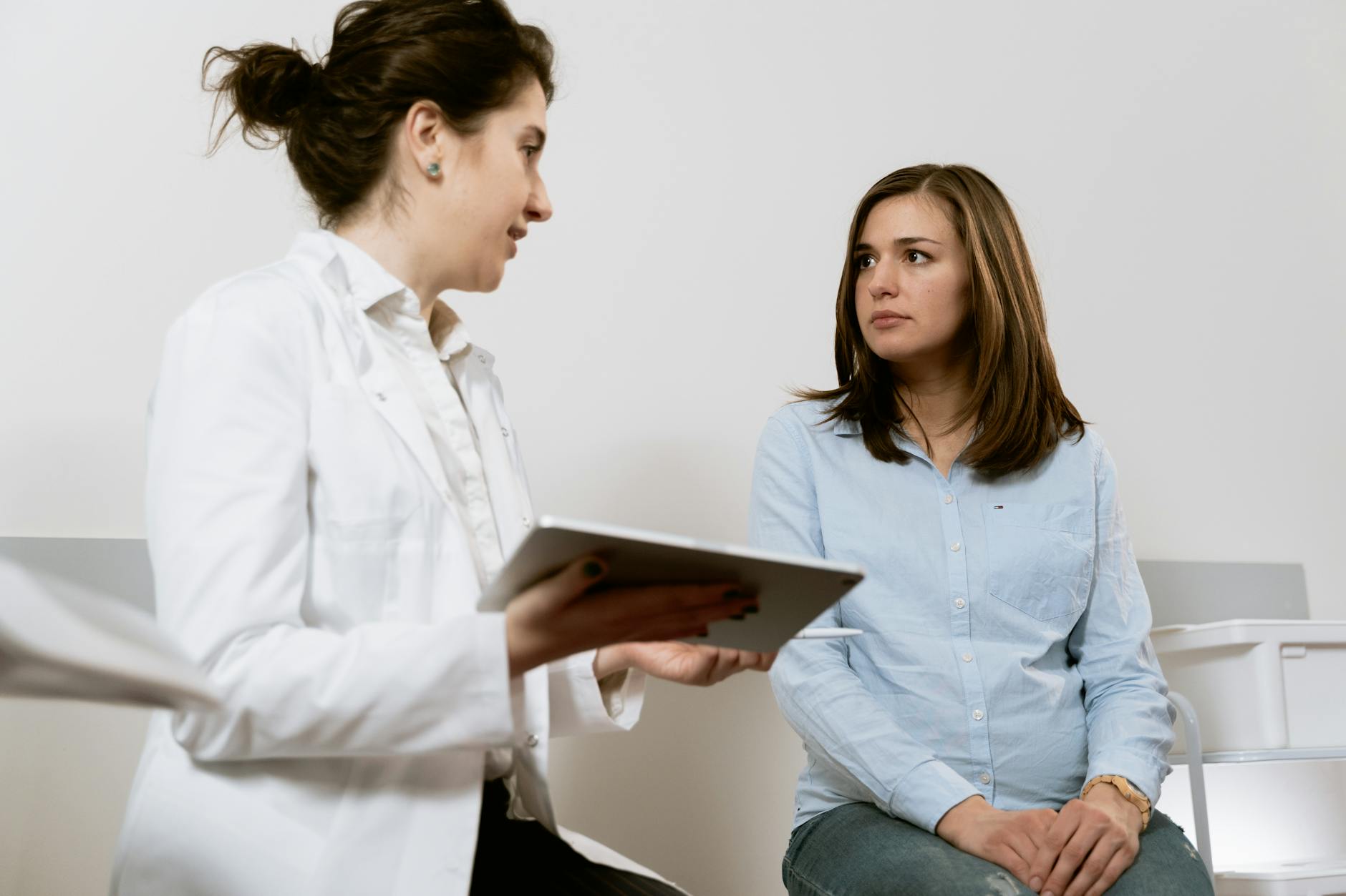 Indian healthcare worker reviewing DataFlow Primary Source Verification documents for SCFHS, DHA, QCHP, or NHRA