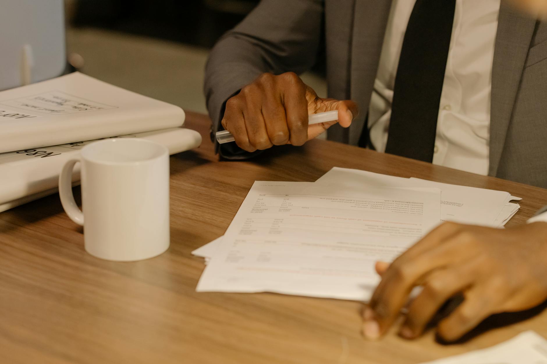 Indian engineer reviewing Saudi documents with apostille, Mosaddaqa, and QVP papers spread on a desk