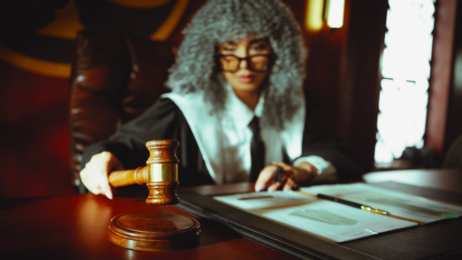 Legal documents beside a court gavel