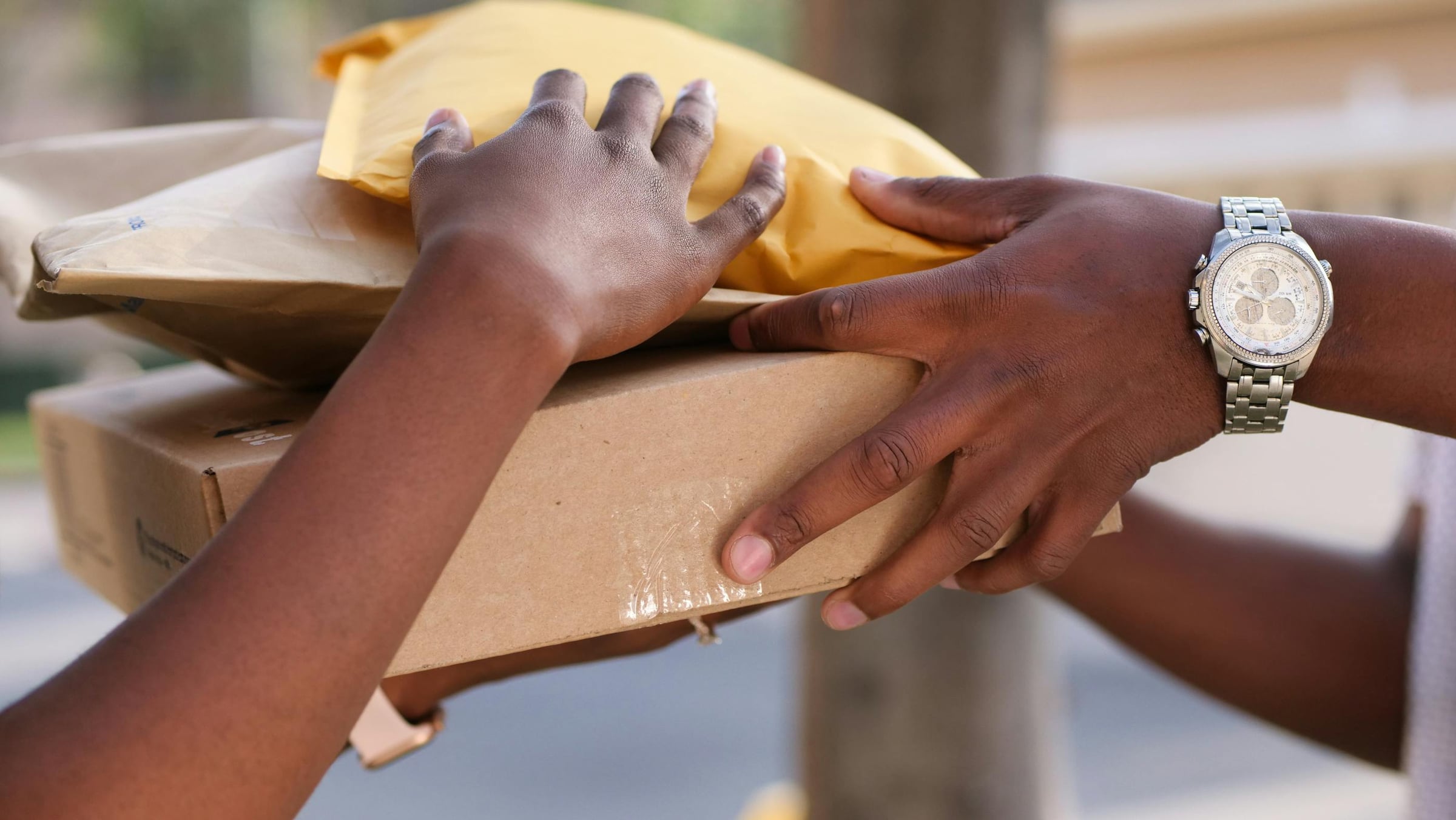 Illustrative handover of padded envelopes for courier dispatch