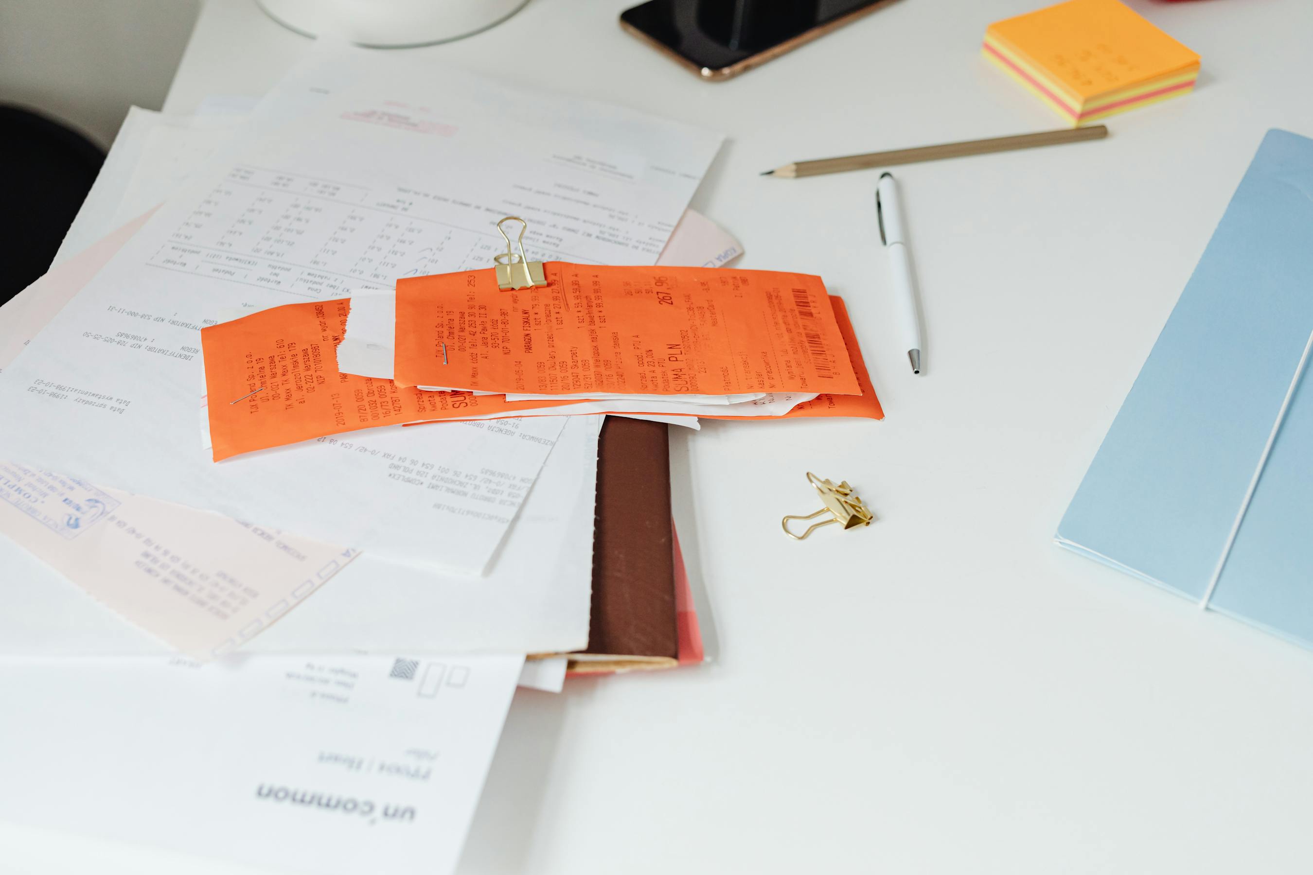 Illustrative documentation workspace with paperwork, stamps and stationery arranged on a desk